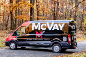 McVay Plumbing, Heating, Cooling & Electrical service van parked on a residential street surrounded by autumn trees in Mars, PA.