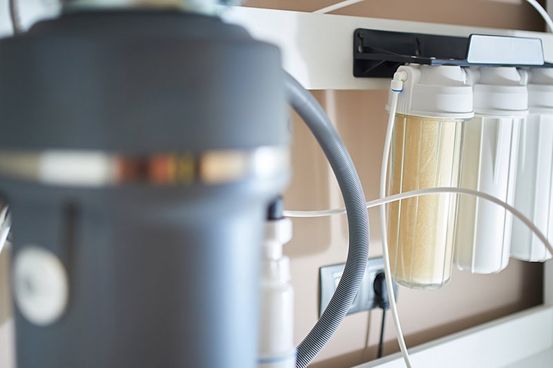 5 Ways to Improve Your Home’s Drinking Water. Photo of a water filtration installed.